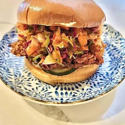Crispy Korean fried chicken sandwich with slaw on a brioche bun
