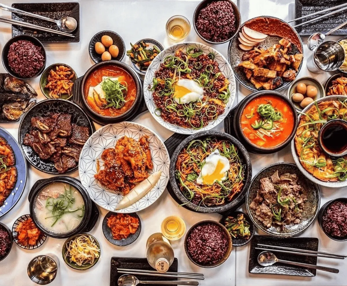 A table filled with Korean dishes and shared side plates at umma